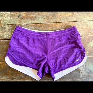 Purple mesh Nike workout shorts.